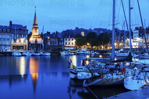 France, Normandy, Honfleur, Boats in harbor and Saint-Etiennei Church in distance