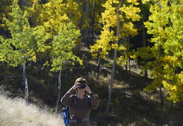 USA, Colorado, Kenosha Pass, Senior woman photographing at Kenosha Pass