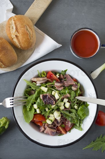 Seafood salad in bowl and cherry juice