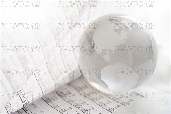 Financial newspaper with crystal ball.