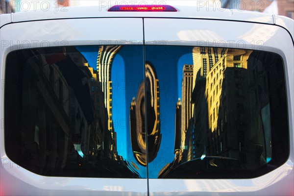 USA, New York State, New York City, Buildings reflecting in windows of van