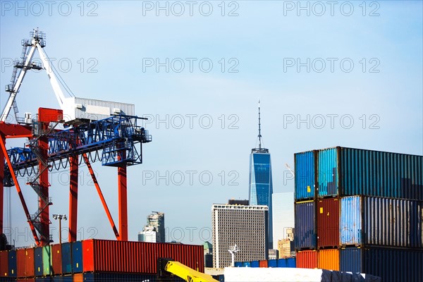 USA, New York, New York City, Cranes in dock with cityscape in background