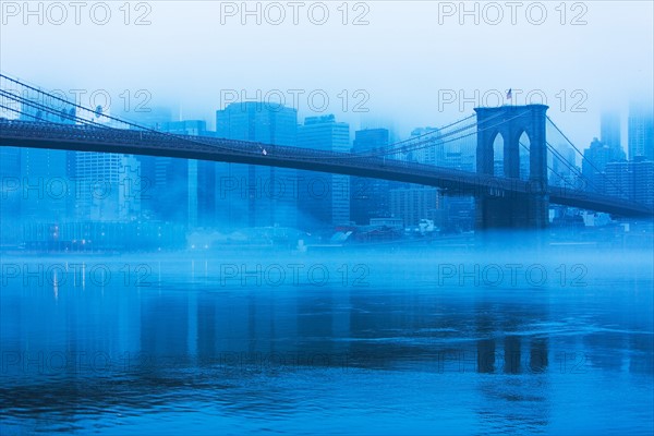 USA, New York, New York City, Manhattan, Brooklyn Bridge over East River in fog