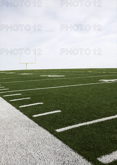 Overcast sky above american football field and goal post