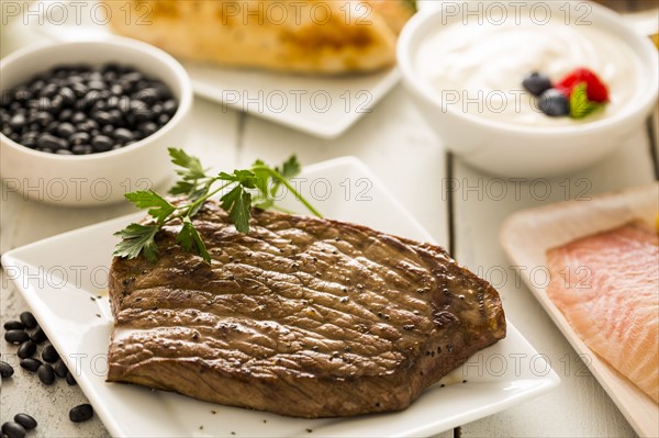 Grilled chicken served with black beans, yogurt and cottage cheese