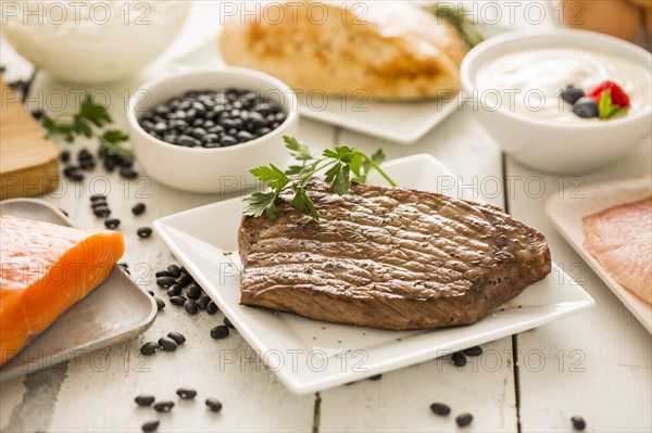 Grilled chicken served with black beans, yogurt and cottage cheese