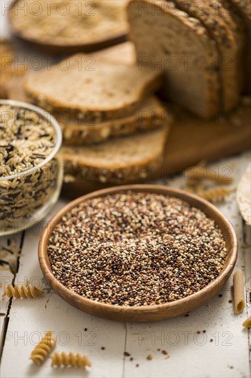 Quinoa in bowl and sliced brown bread in background