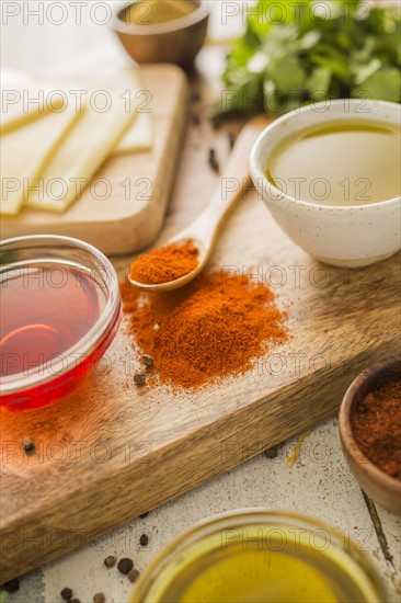 Spices, olive oil and vinegar on cutting board