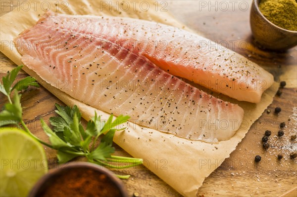 Raw tilapia on cutting board