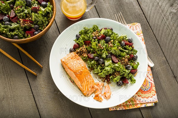 Salmon with salad on plate