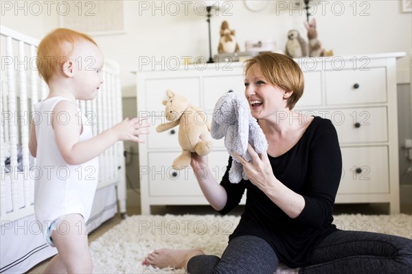 Mother playing with son (12-17 months) in nursery