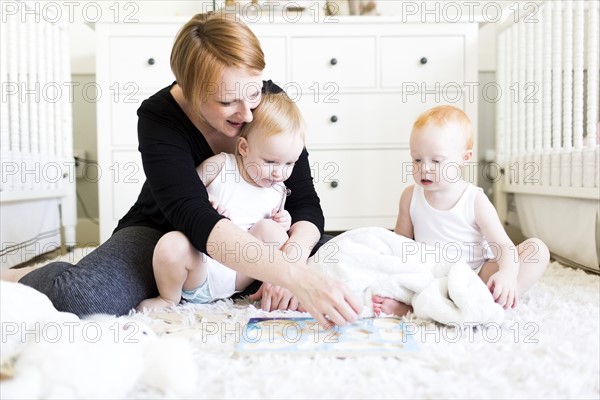 Mother playing with sons (12-17 months) in nursery