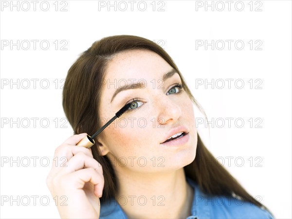 Woman applying mascara