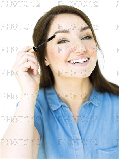 Woman applying mascara