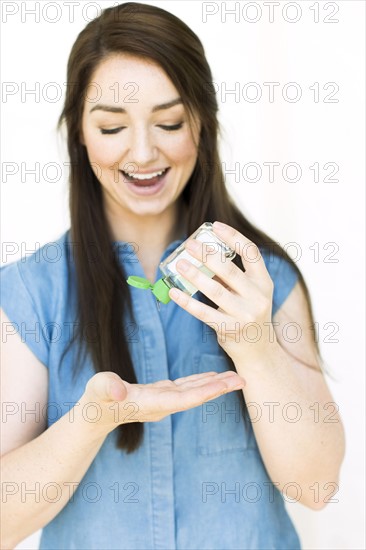 Woman pouring hand sanitizer