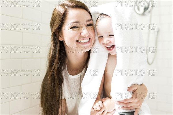 Mother and son (4-5) laughing in bathroom