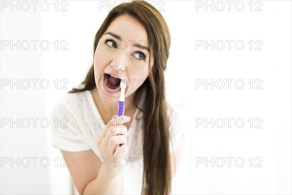 Woman brushing teeth