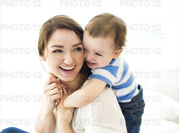 Son (4-5) embracing mother