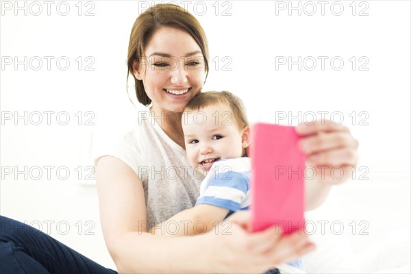 Mother taking selfie with son (4-5)