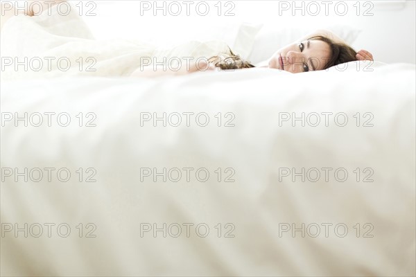 Woman lying on bed