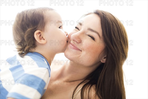 Son (4-5) kissing mother