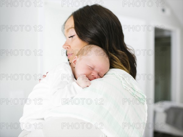 Mother carrying daughter (0-1 months)