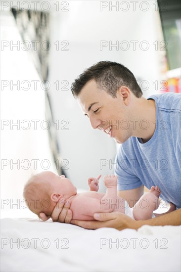 Father carrying daughter (0-1 months)