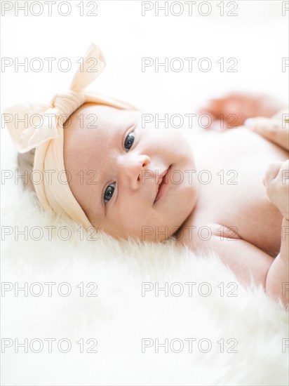 Portrait of girl (0-1 months) with ribbon on head