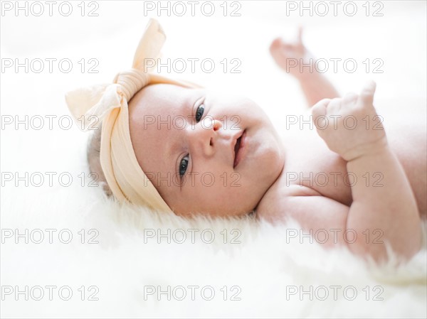 Portrait of girl (0-1 months) with ribbon on head
