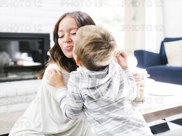 Son (4-5) kissing mother