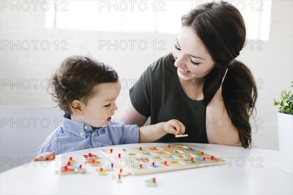 Mother playing alphabet game with son (4-5)