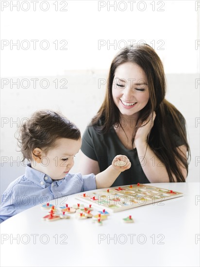 Mother playing alphabet game with son (4-5)