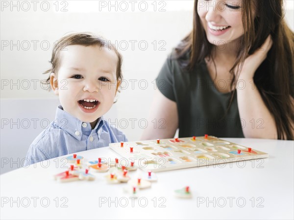 Mother playing alphabet game with son (4-5)