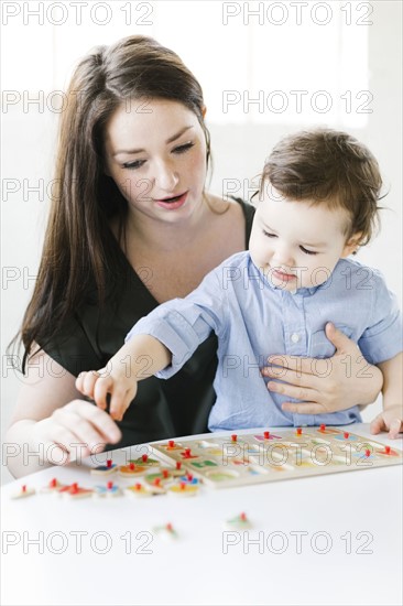 Mother playing alphabet game with son (4-5)