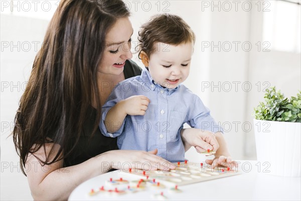 Mother playing alphabet game with son (4-5)