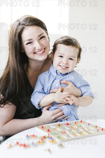 Mother playing alphabet game with son (4-5)