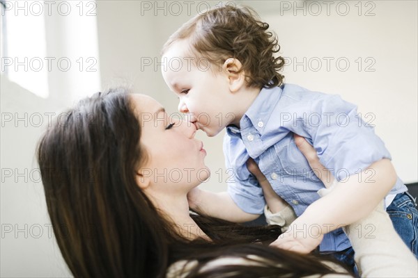 Son (4-5) kissing mother's nose
