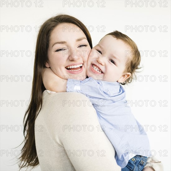Son (4-5) embracing mother