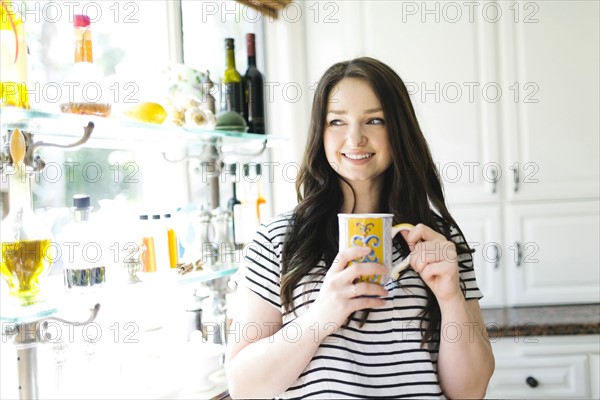 Woman drinking coffee at home