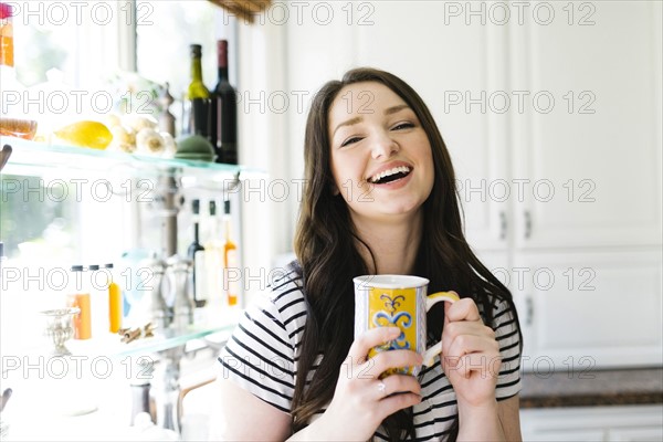 Woman drinking coffee at home