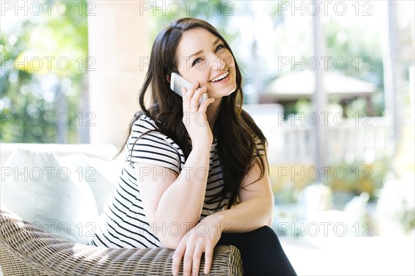 Woman resting on porch on sunny day