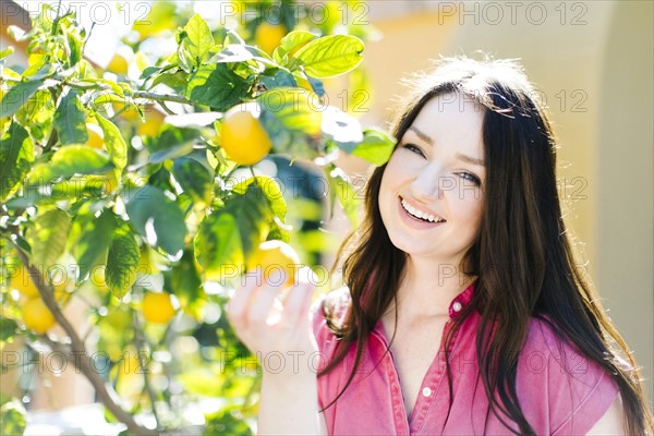 Woman picking oranges