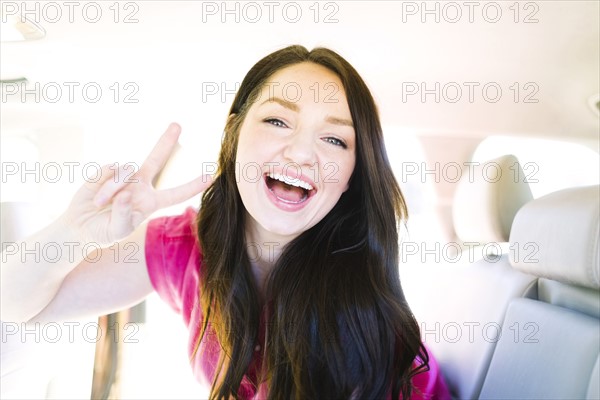 Woman making peace gesture