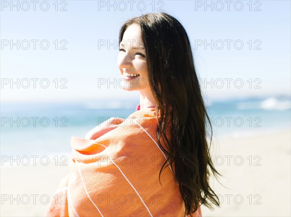 Woman standing by sea