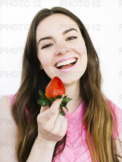 Woman holding fresh strawberry