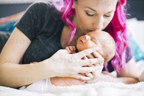 Mother holding newborn son (2-5 months)