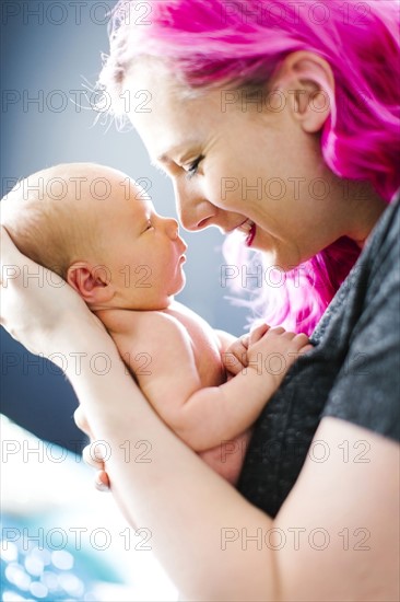 Mother holding newborn son (2-5 months)