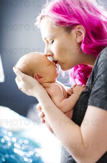 Mother holding newborn son (2-5 months)