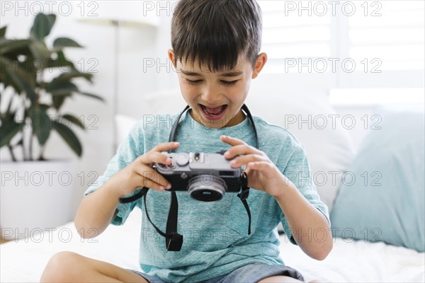 Boy (8-9) watching camera with curiosity