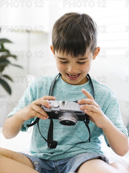 Boy  (8-9) watching camera  with curiosity